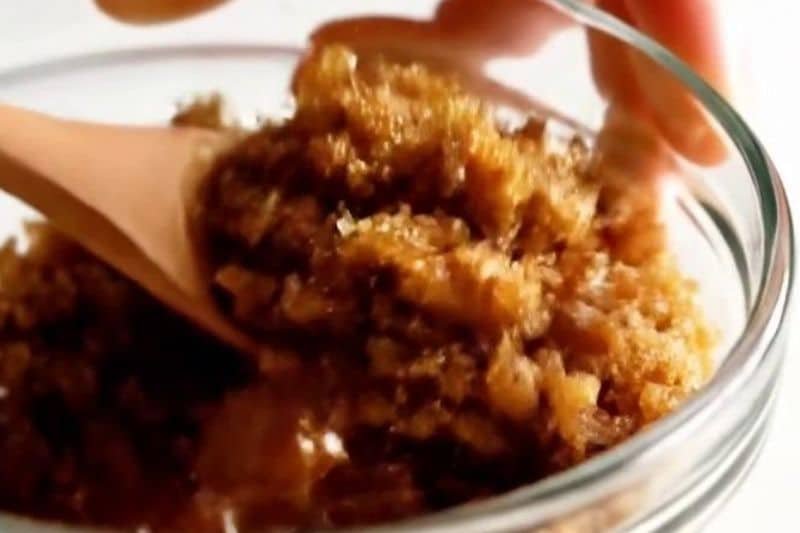 Brown sugar and coconut oil scrub mixture in small bowl
