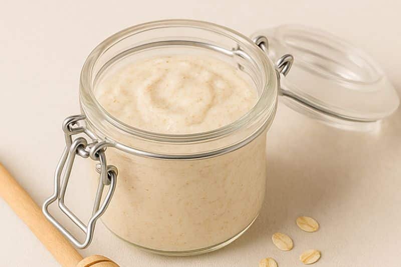 DIY oatmeal and yogurt soothing scrub in glass jar with open lid
