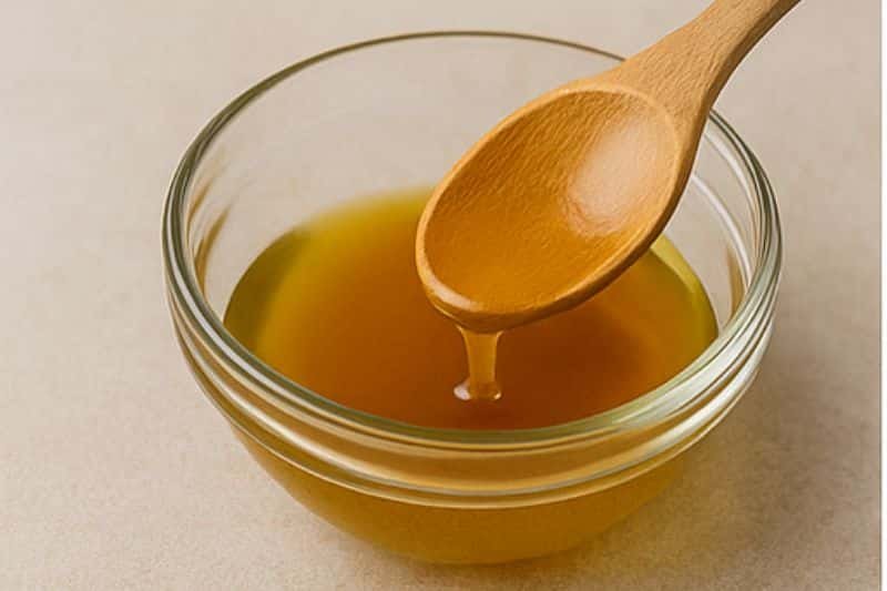 Melting beeswax and oils in a double boiler for homemade pumpkin spice lip balm