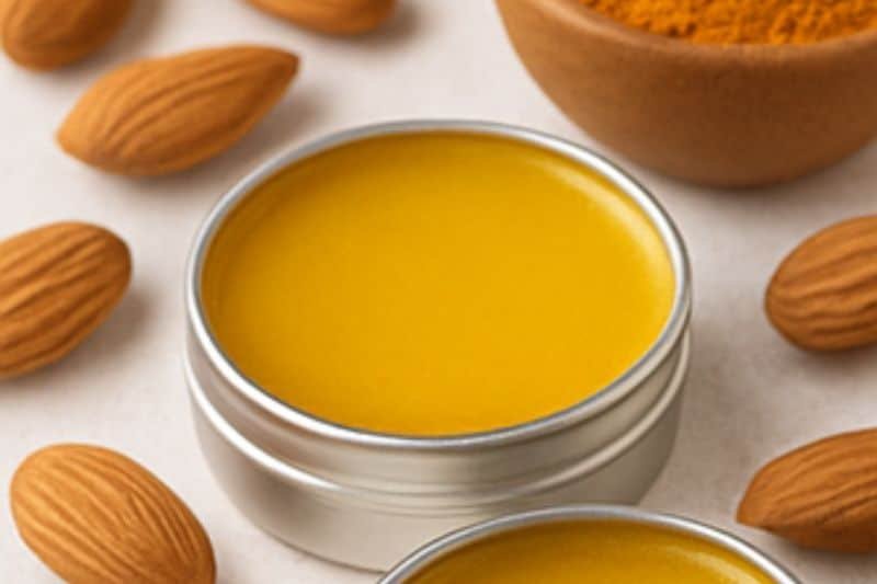 DIY turmeric lip balm in small tins with turmeric powder and almond oil