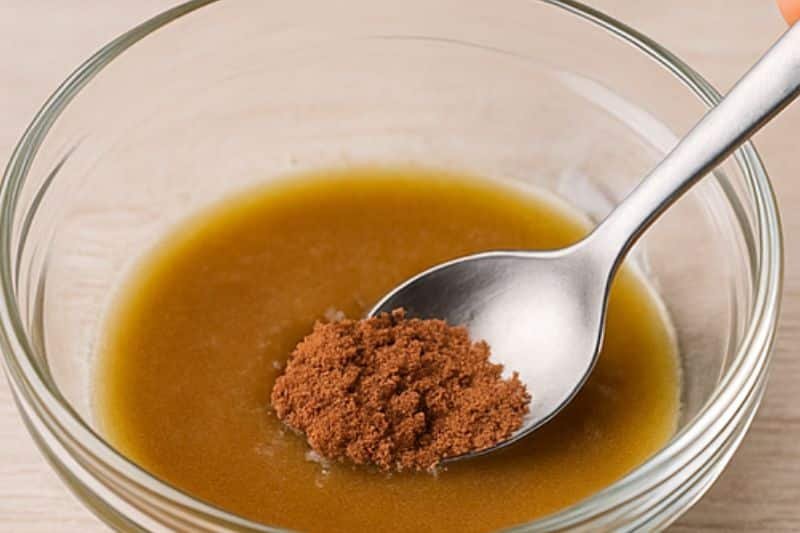 Melting beeswax and oils, then whisking in cocoa powder for chocolate mint lip balm